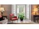 Sunlit bay window area with a comfortable armchair and lush potted plant, creating a cozy nook at 520 Weatherend Ct, Johns Creek, GA 30022