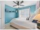 Charming bedroom with teal walls, a large shuttered window and recessed shelving at 520 Weatherend Ct, Johns Creek, GA 30022