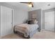 Neutral bedroom featuring a bed, ceiling fan, and two white paneled doors at 520 Weatherend Ct, Johns Creek, GA 30022