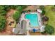 Aerial view of a community pool, playground and picnic area surrounded by lush landscaping at 520 Weatherend Ct, Johns Creek, GA 30022
