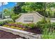 Landscaped brick entrance sign for Breckenridge-Johns Creek with colorful flowers and greenery at 520 Weatherend Ct, Johns Creek, GA 30022