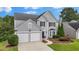 Well-maintained home with two-car garage, gray siding, and lush landscaping in a desirable neighborhood at 520 Weatherend Ct, Johns Creek, GA 30022