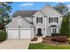 Charming two-story home features a well-manicured lawn, two-car garage, and inviting front entrance at 520 Weatherend Ct, Johns Creek, GA 30022