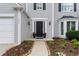 Charming home exterior with landscaped front yard, walkway and traditional front door at 520 Weatherend Ct, Johns Creek, GA 30022