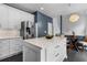 Bright kitchen with stainless steel refrigerator, white cabinets, dark backsplash and modern fixtures at 520 Weatherend Ct, Johns Creek, GA 30022