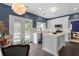 Bright eat-in kitchen with marble countertops, stainless appliances, island, and access to backyard patio at 520 Weatherend Ct, Johns Creek, GA 30022