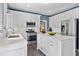 Spacious kitchen with stainless steel appliances, marble countertops, island, and white cabinetry at 520 Weatherend Ct, Johns Creek, GA 30022
