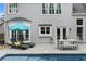 Beautiful backyard pool area with lounge chairs, dining table, and a well-maintained patio at 520 Weatherend Ct, Johns Creek, GA 30022