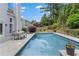 Inviting swimming pool with a patio area, landscaping, and ample space for outdoor entertainment at 520 Weatherend Ct, Johns Creek, GA 30022