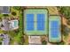 Aerial view of community tennis courts with neighborhood homes nearby at 520 Weatherend Ct, Johns Creek, GA 30022