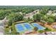 Aerial view of community tennis courts surrounded by mature trees and lush landscaping at 520 Weatherend Ct, Johns Creek, GA 30022