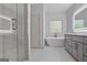 Spa-like bathroom featuring a soaking tub, glass shower, and modern vanity at 1155 Graystone Xing, Alpharetta, GA 30005