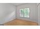 Clean and bright bedroom with hardwood floors, a large window, and neutral walls at 1155 Graystone Xing, Alpharetta, GA 30005