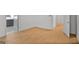Bedroom space with sleek hardwood flooring, white walls, and a view into an ensuite bath at 1155 Graystone Xing, Alpharetta, GA 30005