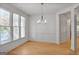 Cozy dining nook with large windows, hardwood floors, and modern light fixture, perfect for casual dining at 1155 Graystone Xing, Alpharetta, GA 30005