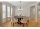 Elegant dining room featuring a round table, stylish chandelier, and large windows for ample natural light at 1155 Graystone Xing, Alpharetta, GA 30005