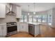 Modern kitchen featuring stainless steel appliances, white cabinets, and a large island for cooking and entertaining at 1155 Graystone Xing, Alpharetta, GA 30005