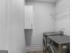 A modern laundry room featuring new front loading appliances and storage cabinet at 1155 Graystone Xing, Alpharetta, GA 30005