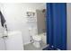 Clean bathroom featuring a shower, sink, toilet, and storage shelves at 3854 Bright Star Road, Douglasville, GA 30135