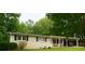 Traditional home with neat landscaping, black shutters, covered porch, and car parking in a tranquil setting at 3854 Bright Star Road, Douglasville, GA 30135