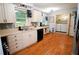 Bright kitchen with white cabinets, stainless appliances, and an adjacent laundry area at 3854 Bright Star Road, Douglasville, GA 30135