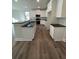 Stylish kitchen with white cabinets, black countertops, island and modern appliances at 3867 Lockaby Way, Lawrenceville, GA 30044