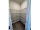Walk-in pantry featuring wire shelving for organized storage and hardwood floors at 3867 Lockaby Way, Lawrenceville, GA 30044