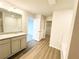Bathroom with granite countertop vanity and wood-look vinyl flooring at 5443 Belle Meade Dr, Villa Rica, GA 30180