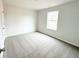Bedroom with a large window providing natural light to the neutral carpeting at 5443 Belle Meade Dr, Villa Rica, GA 30180