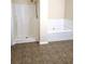 Bright bathroom with a combination shower and soaking tub at 6398 Shadow Sq, Lithonia, GA 30058