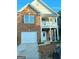 Two-story brick house with a front-facing garage and porch at 6398 Shadow Sq, Lithonia, GA 30058