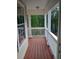 Front porch with wood flooring and white railings at 6398 Shadow Sq, Lithonia, GA 30058