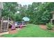The backyard features a well-maintained lawn, landscaping, mature trees, an above ground pool and deck area at 80 Broadlands Dr, White, GA 30184