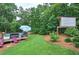 The backyard features a well-maintained lawn, landscaping, mature trees, an above ground pool and deck area at 80 Broadlands Dr, White, GA 30184