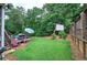 The backyard features a well-maintained lawn, landscaping, mature trees, an above ground pool and deck area at 80 Broadlands Dr, White, GA 30184