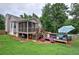 Charming home with screened porch, a deck and above ground pool area surrounded by lush trees and landscaping at 80 Broadlands Dr, White, GA 30184