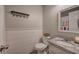 Bathroom featuring wainscoting, toilet, granite countertop, sink, and mirror at 80 Broadlands Dr, White, GA 30184