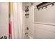 Bright bathroom featuring shower with shelf, wainscoting, and towel hooks at 80 Broadlands Dr, White, GA 30184