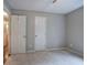Bedroom featuring neutral colored walls, carpet flooring, and two white doors at 80 Broadlands Dr, White, GA 30184