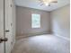 Neutral bedroom showcasing a ceiling fan and a window offering natural light at 80 Broadlands Dr, White, GA 30184