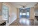 Bright dining area with a bay window, wood floors, and access to the deck at 80 Broadlands Dr, White, GA 30184