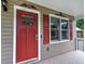 Close up of the front door with an American flag waving on the front porch at 80 Broadlands Dr, White, GA 30184