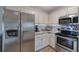 Updated kitchen with stainless steel appliances, granite countertops, and ample cabinet space at 80 Broadlands Dr, White, GA 30184