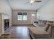 Spacious living room with hardwood floors, stone fireplace, and lots of natural light at 80 Broadlands Dr, White, GA 30184