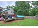The backyard features an above ground pool with an adjacent deck and outdoor seating surrounded by trees at 80 Broadlands Dr, White, GA 30184