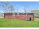 This backyard features a well-maintained lawn and a charming brick home exterior at 101 Longstreet Cir, Oxford, GA 30054