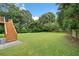 Large backyard featuring an expansive lawn and wooden staircase to second-floor deck at 173 Cline Smith Ne Rd, Cartersville, GA 30121