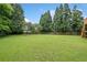 Expansive backyard featuring lush green grass and mature trees, ideal for outdoor activities at 173 Cline Smith Ne Rd, Cartersville, GA 30121