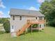 Back view of home with wooden deck, stairs, and a well-maintained lawn at 173 Cline Smith Ne Rd, Cartersville, GA 30121