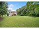 Expansive backyard featuring a lush lawn, deck access, and room to roam at 173 Cline Smith Ne Rd, Cartersville, GA 30121